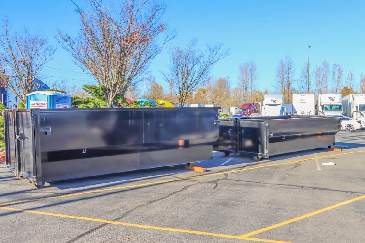 Professional dumpster rental service with roll-off container on residential driveway in Alabaster